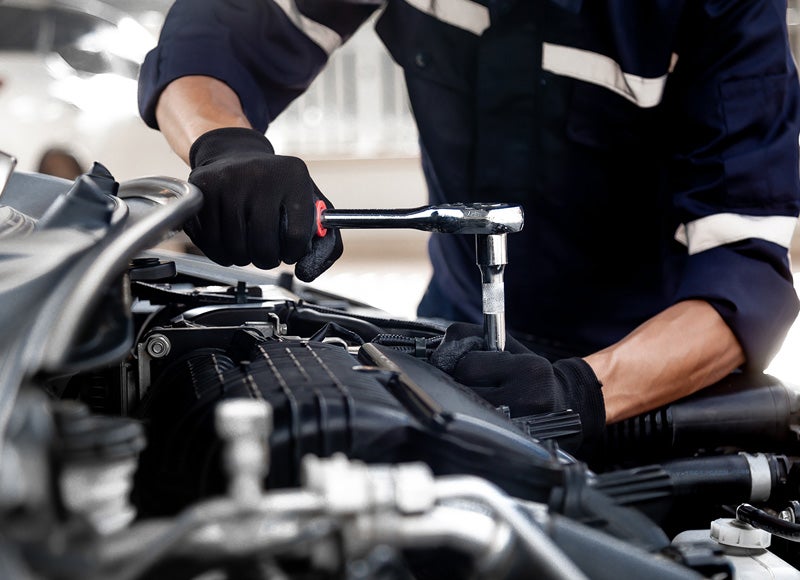 service tech working on car